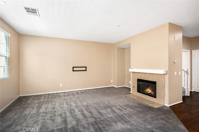 a view of a dining room with furniture a chandelier and wooden floor