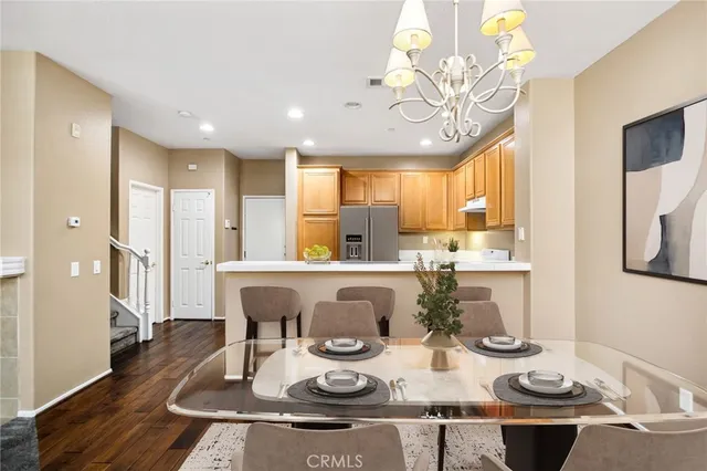 a kitchen with stainless steel appliances granite countertop a sink a stove and a refrigerator