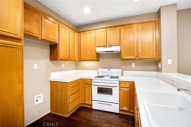 a view of a hallway with wooden floor and entryway