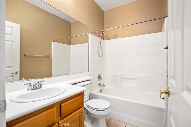 a view of an empty room and chandelier fan