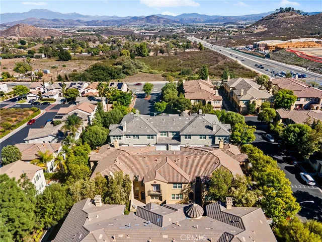 an aerial view of residential houses with outdoor space and swimming pool