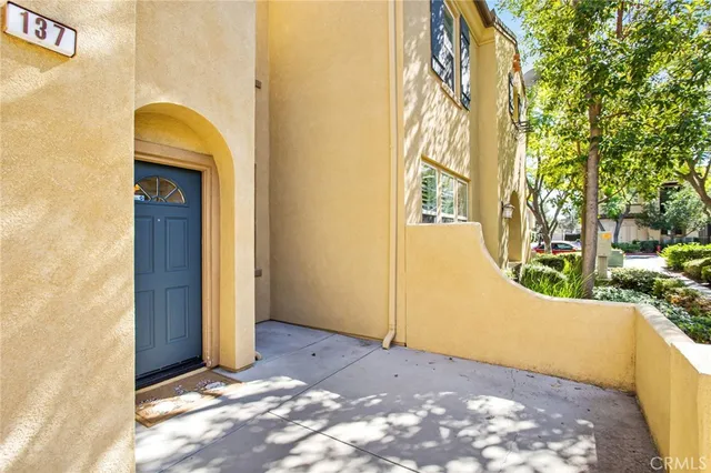 a view of hallway with window and wooden floor