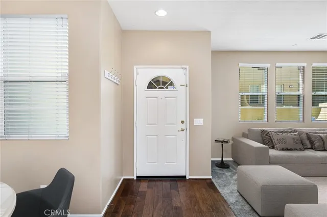 a kitchen with a wooden floor and a window
