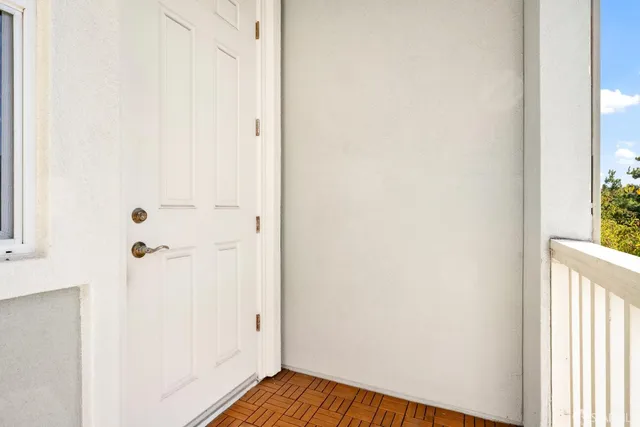 a view of a bedroom with wooden floor