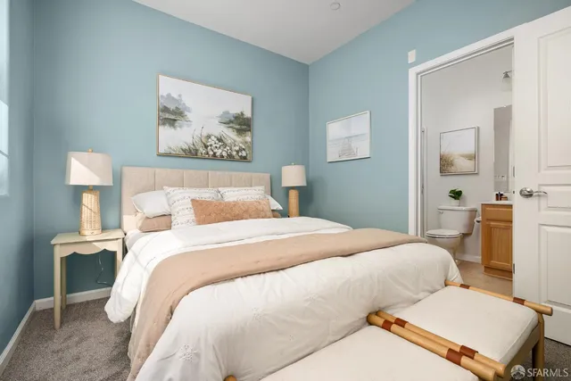 a bedroom with a bed and a painting on the wall