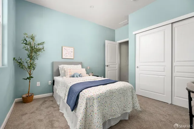 a bedroom with a bed and a potted plant