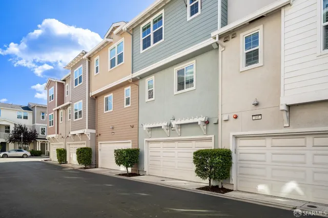 a white house that has a street sign on it