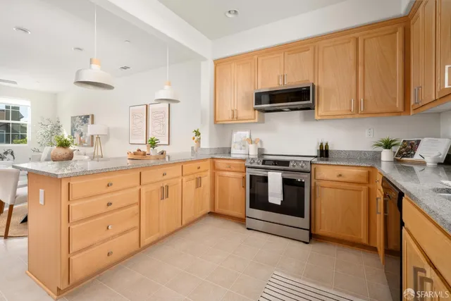 a kitchen with white cabinets stainless steel appliances and sink