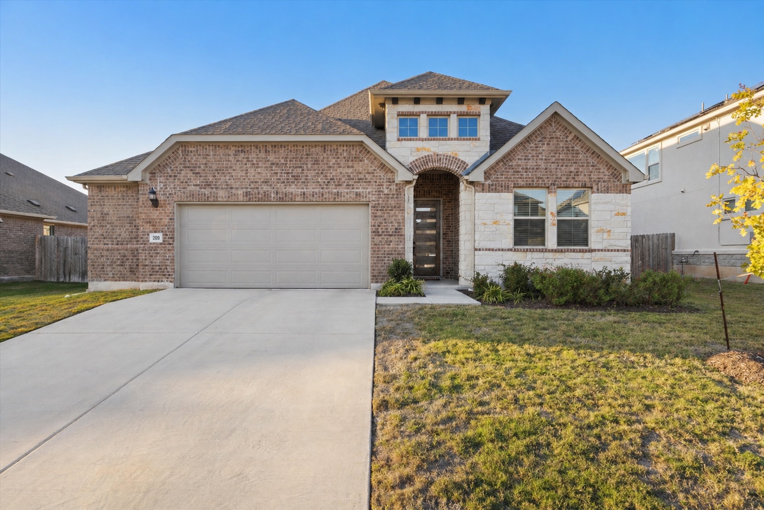 209 Rainier Drive Kyle, TX 78640 - Photo 24 of 24 Brick and stone façade with an arched entry
