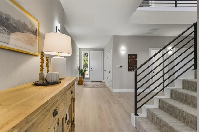 a bedroom with furniture and wooden floor