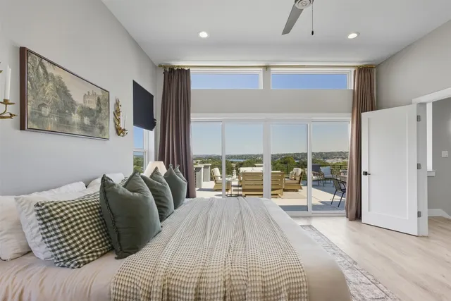 a bedroom with a large bed and a large window