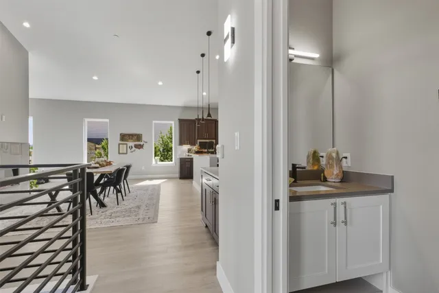 a kitchen with kitchen island a counter top space a sink stainless steel appliances and cabinets