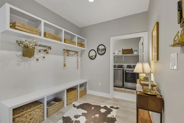 a living room with stainless steel appliances kitchen island granite countertop a refrigerator and a stove top oven