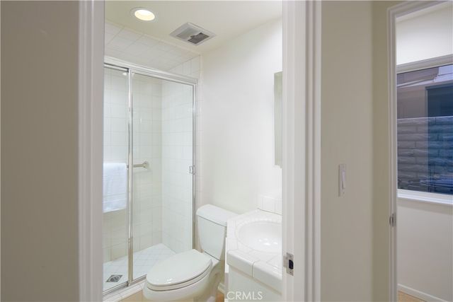 a white toilet sitting next to a bathroom sink