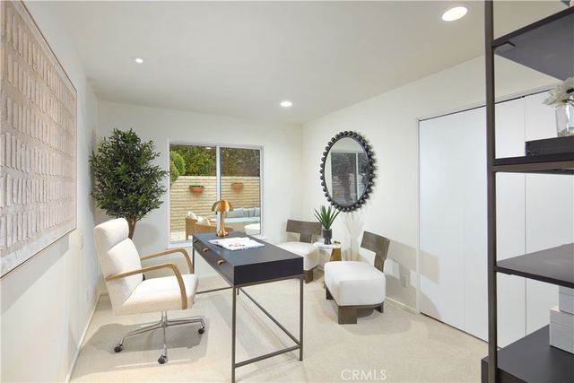 a living room with furniture a window and a table