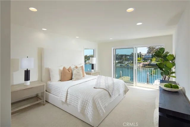 a bedroom with a large bed and a potted plant