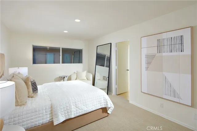 a bedroom with a bed and a mirror