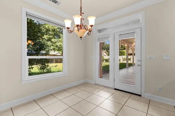 a kitchen with granite countertop a sink window and cabinets