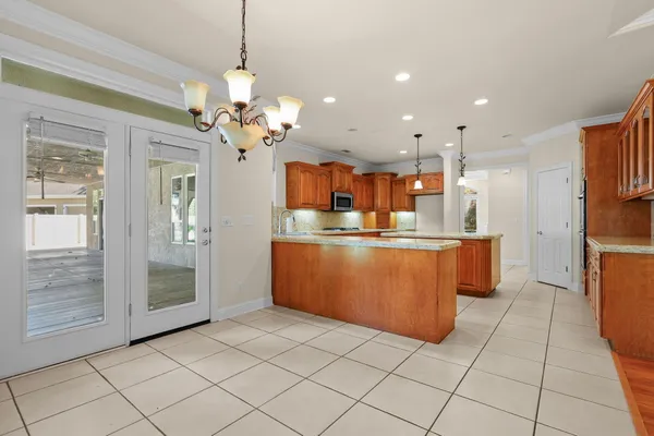 a kitchen with stainless steel appliances granite countertop a sink and a microwave
