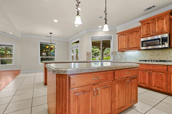 a kitchen with stainless steel appliances granite countertop a sink and a stove