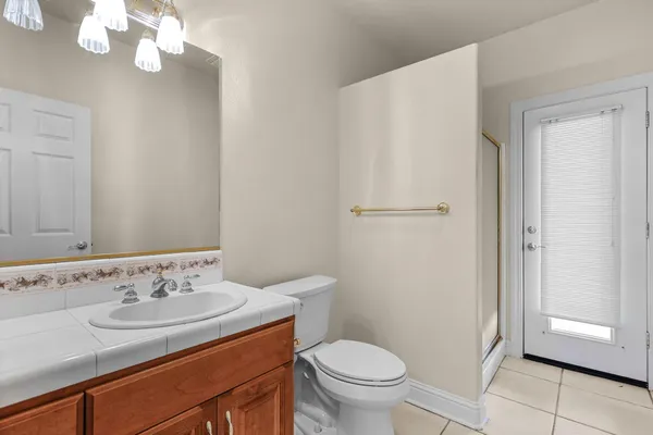 a spacious bedroom with a bed and a chandelier