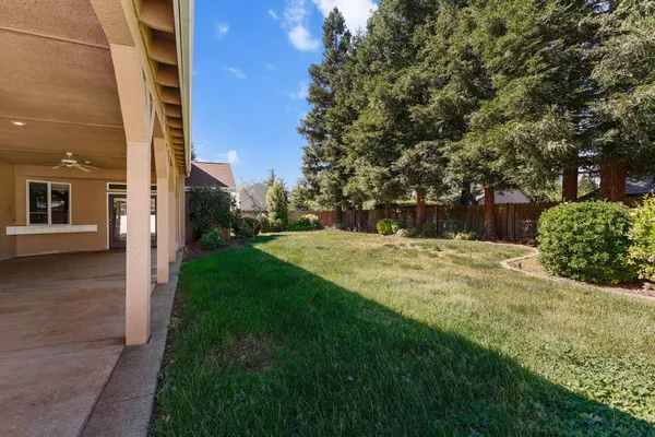 a view of a house with a backyard and porch