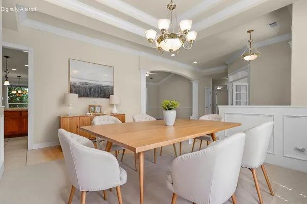a view of a hallway with chandelier and entryway