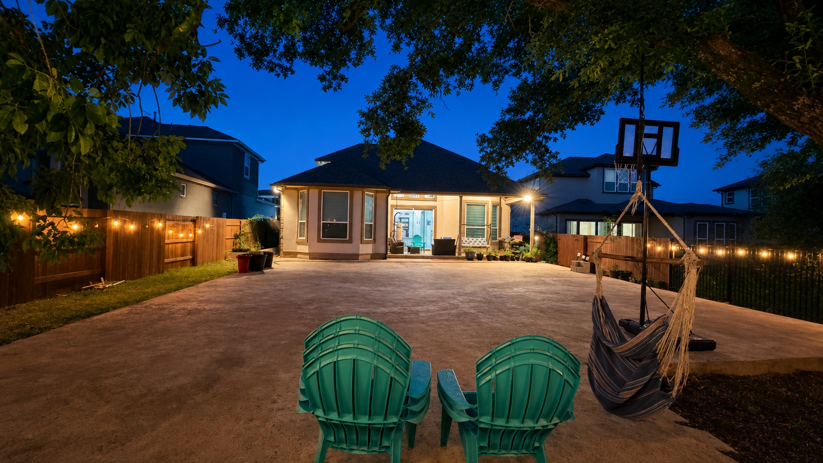 7290 Shoshoni Loop Round Rock, TX 78681 - Photo 6 of 6 An inviting backyard oasis offers ample space for recreation and relaxation beneath strings of charming accent lighting.