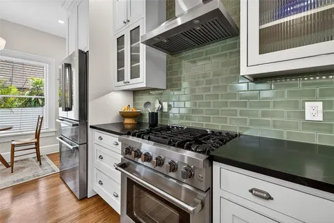 a kitchen with stainless steel appliances granite countertop a stove and a cabinets