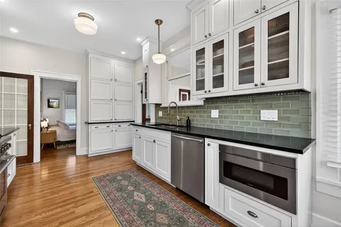 a kitchen with stainless steel appliances granite countertop a stove a sink and a granite counter tops
