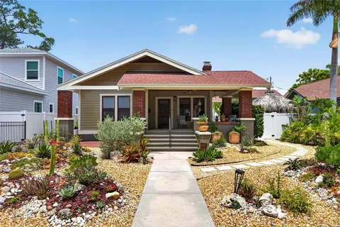 a front view of a house with sitting area and garden