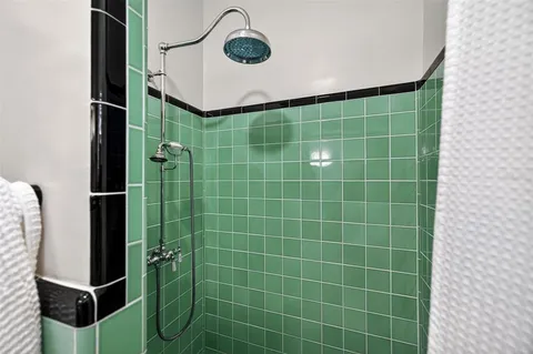 a bathroom with a shower and a mirror