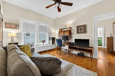 a living room with furniture fireplace and a window