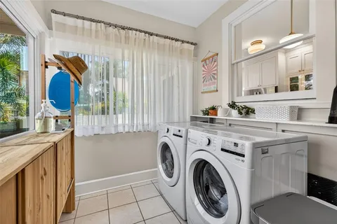 a utility room with sink dryer and washer