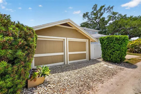 a view of a house with a yard and potted plants