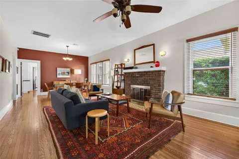 a living room with furniture fireplace and window