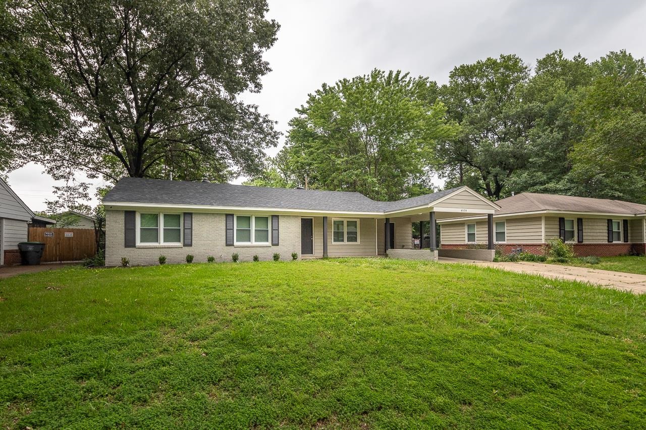 4574 Boyce Road Memphis, TN 38117 - Photo 1 of 28 a front view of a house with a garden