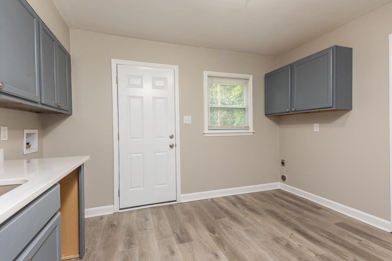 4574 Boyce Road Memphis, TN 38117 - Photo 12 of 28 a view of a kitchen with sink and dishwasher with wooden floor
