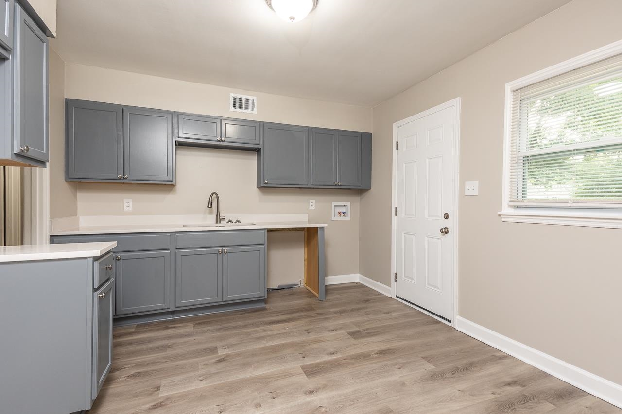 4574 Boyce Road Memphis, TN 38117 - Photo 13 of 28 a kitchen with granite countertop a sink cabinets and window