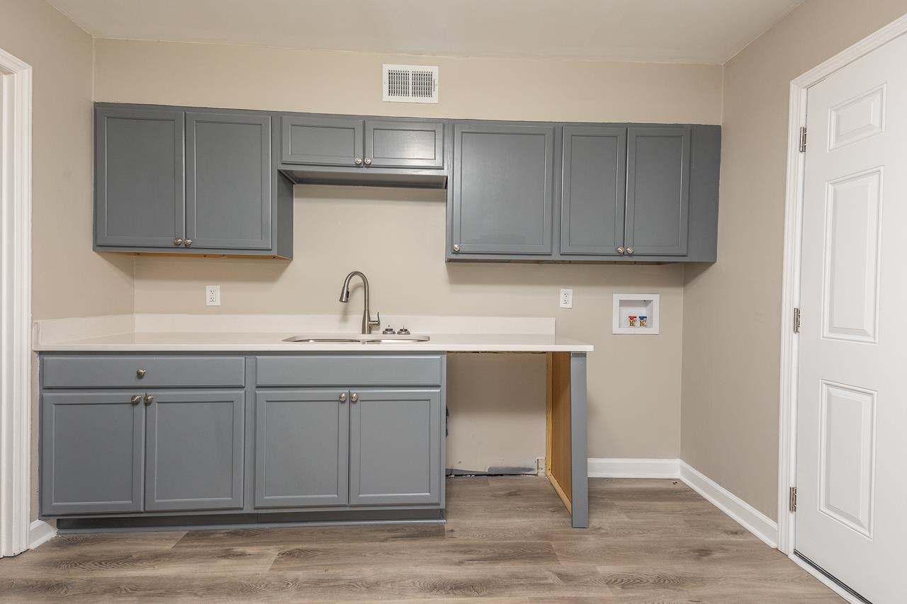 4574 Boyce Road Memphis, TN 38117 - Photo 14 of 28 a kitchen with sink and cabinets