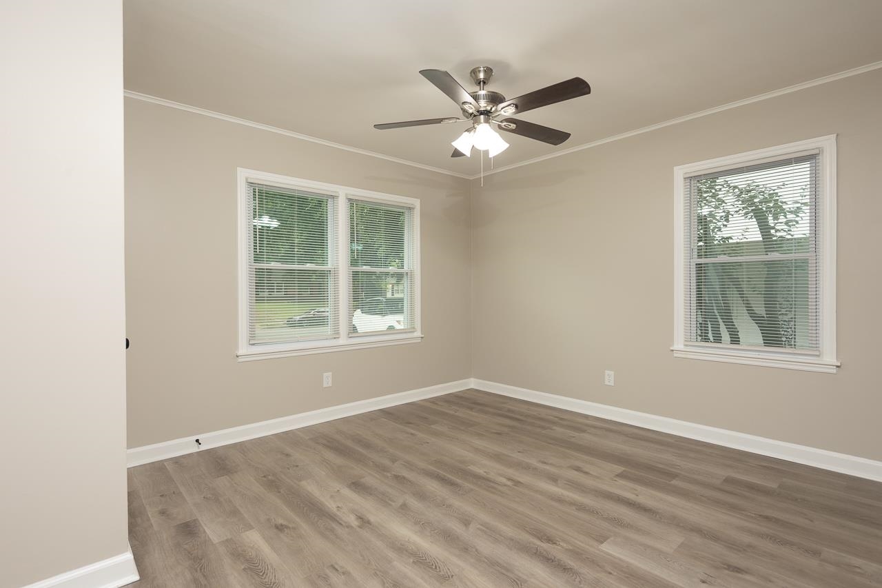 4574 Boyce Road Memphis, TN 38117 - Photo 16 of 28 a view of an empty room with a window and wooden floor