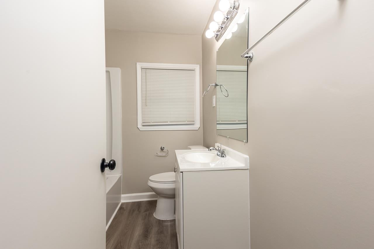 4574 Boyce Road Memphis, TN 38117 - Photo 17 of 28 a bathroom with a sink a toilet and a mirror