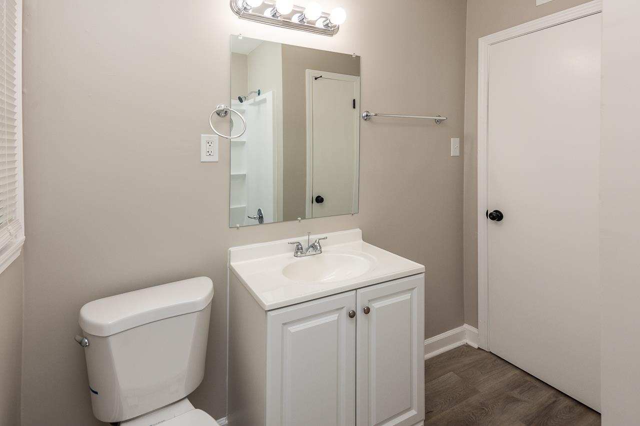 4574 Boyce Road Memphis, TN 38117 - Photo 18 of 28 a bathroom with a toilet sink and mirror