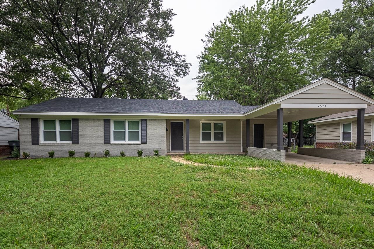 4574 Boyce Road Memphis, TN 38117 - Photo 27 of 28 a front view of a house with a garden and trees