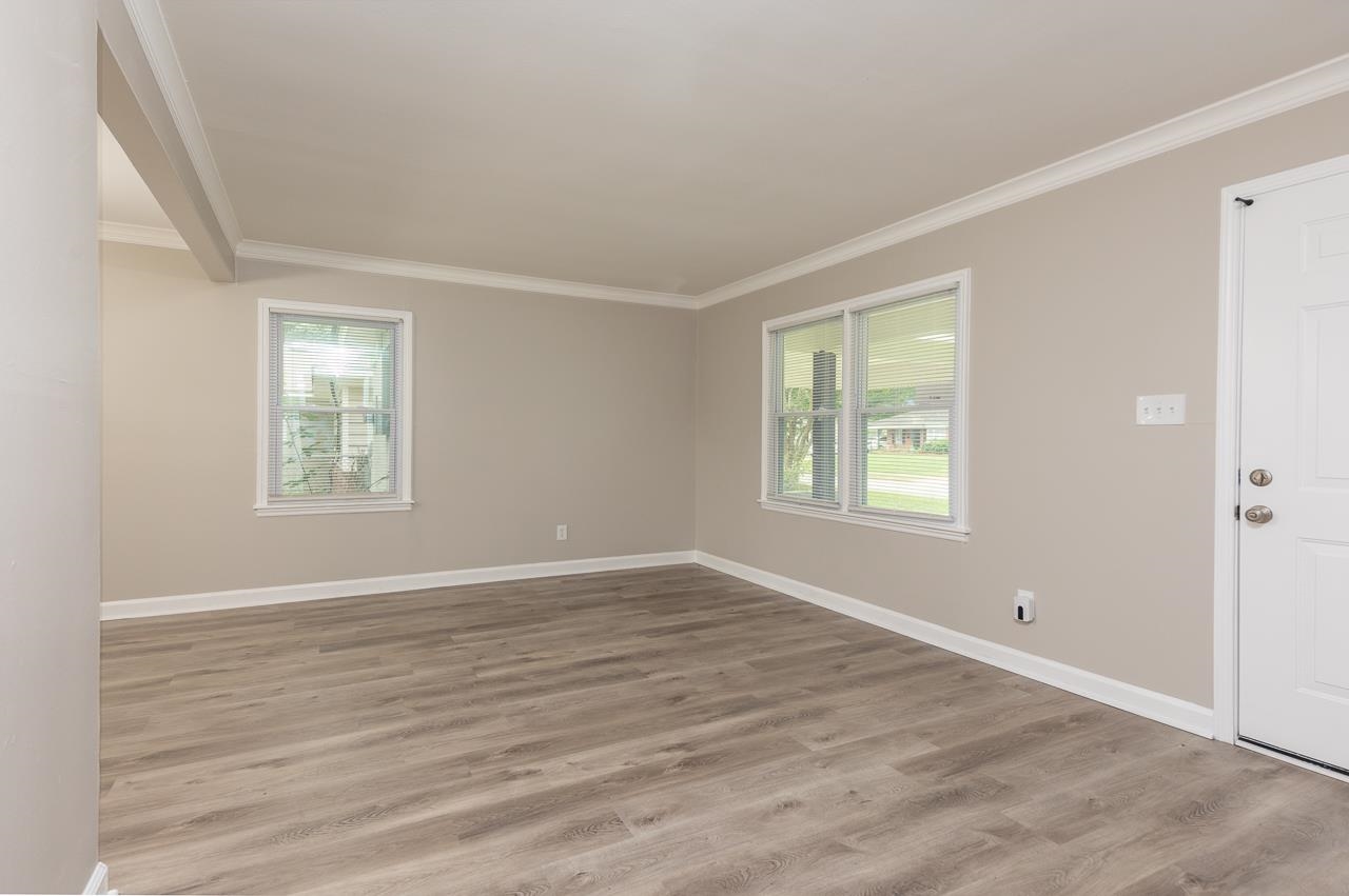 4574 Boyce Road Memphis, TN 38117 - Photo 4 of 28 a view of an empty room with wooden floor and a window