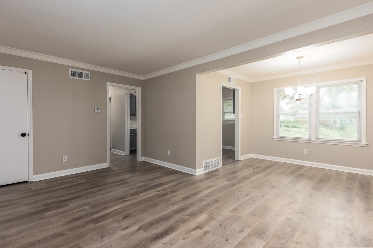 4574 Boyce Road Memphis, TN 38117 - Photo 6 of 28 a view of an empty room with wooden floor and a window