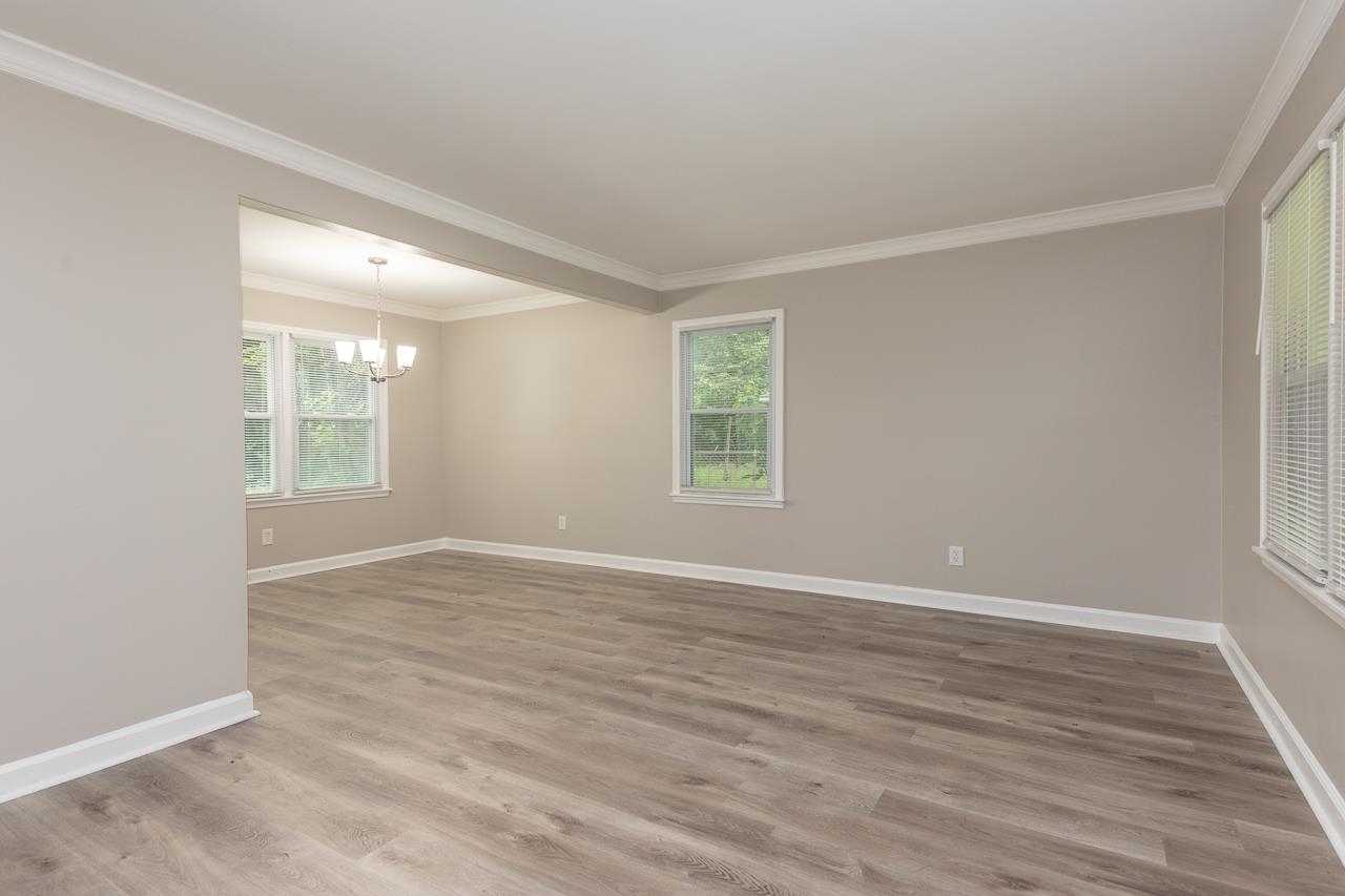 4574 Boyce Road Memphis, TN 38117 - Photo 8 of 28 an empty room with wooden floor and windows
