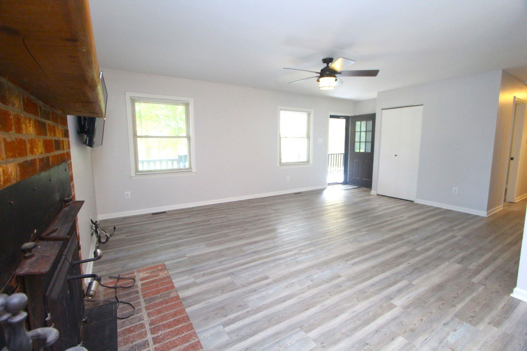 4161 Range Road Stem, NC 27581 - Photo 12 of 43 a view of an empty room with wooden floor and a window