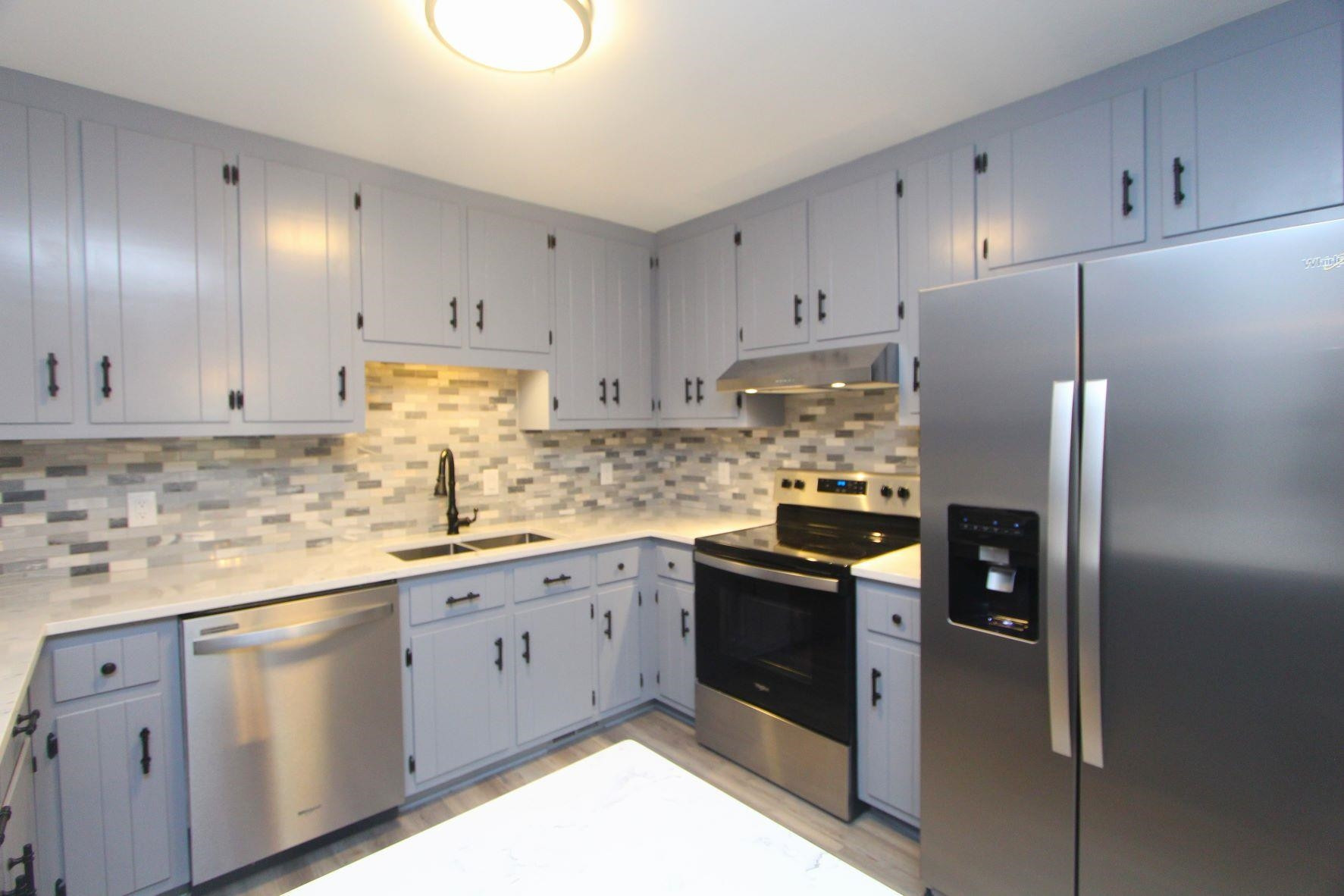 4161 Range Road Stem, NC 27581 - Photo 14 of 43 a kitchen with stainless steel appliances granite countertop a refrigerator sink and cabinets