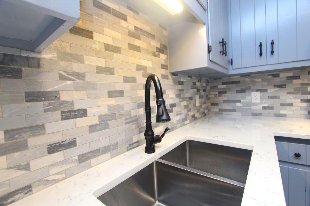 4161 Range Road Stem, NC 27581 - Photo 16 of 43 a kitchen with granite countertop a sink and a stove